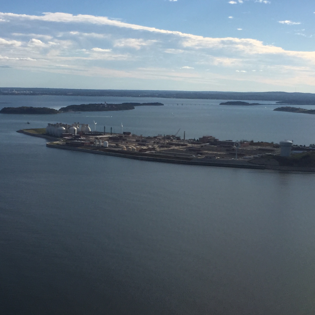 Aerial view of a sewage treatment facility, surrounded by the ocean. ()